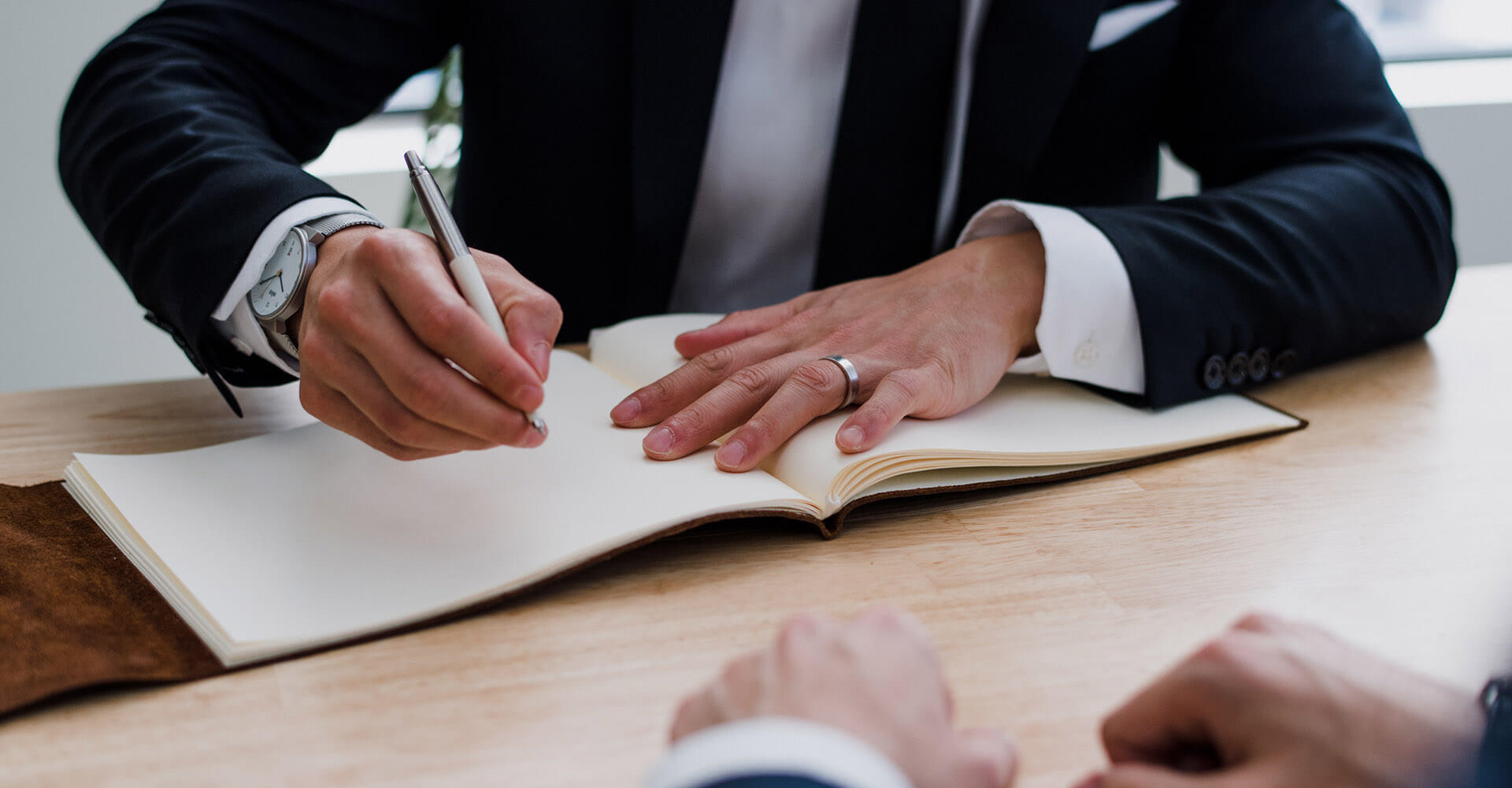 Client signing paperwork with a lawyer